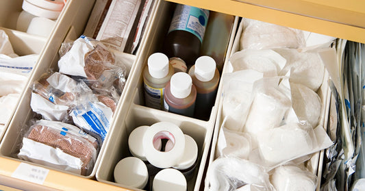 An open drawer drawer with numerous compartments. Each compartment has different medical supplies.